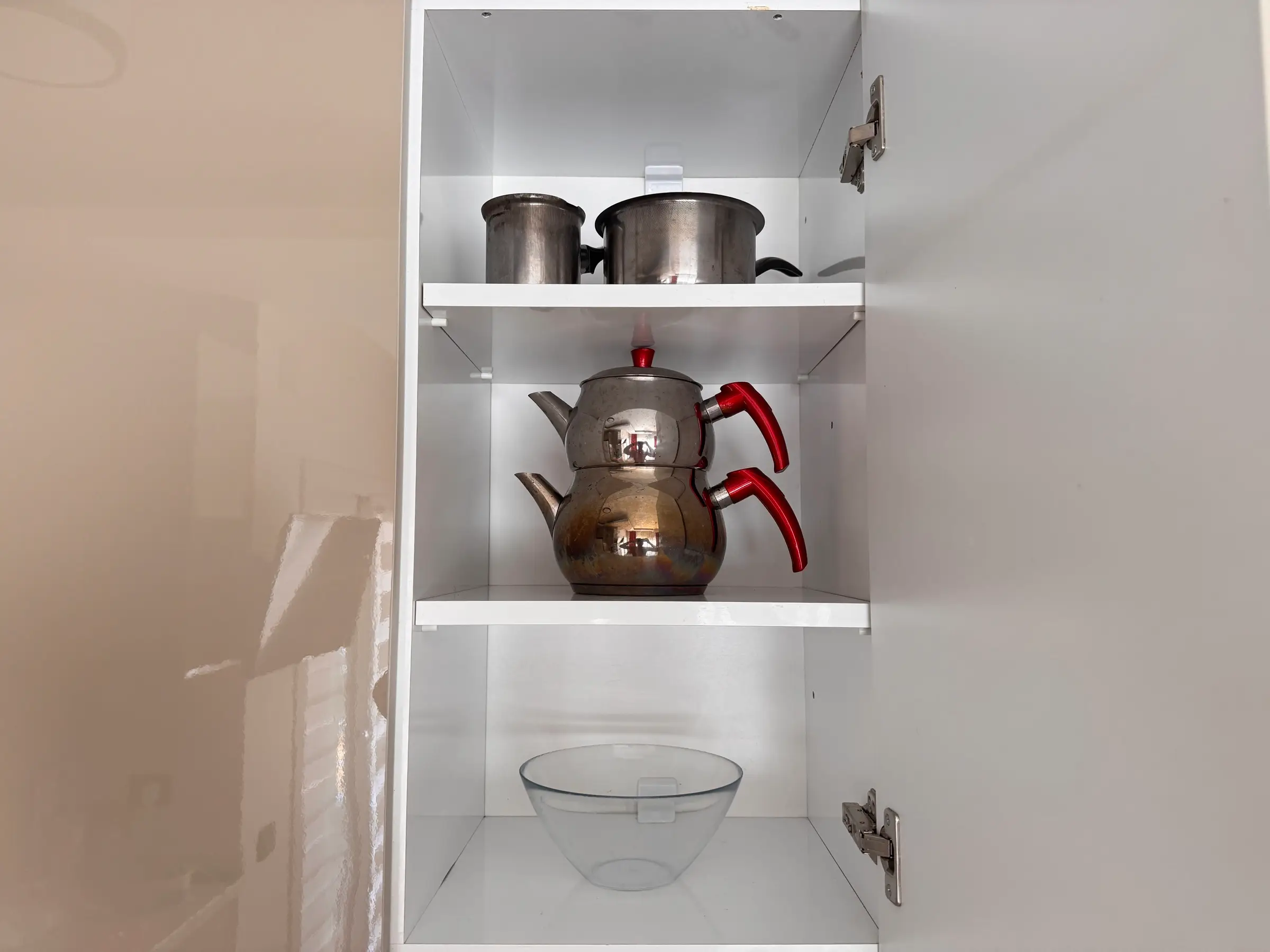 Kitchen cupboard with pots, pans and a çaydanlık
